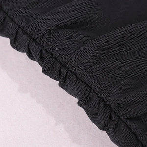 Detailed close-up of breathable black honeycomb mesh fabric with elastic ruched edges