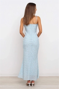 Detail view of backless design with tie-up straps on light blue floral maxi dress