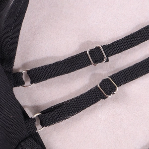 Detail of adjustable black shoulder straps with silver metal buckles on a slim dress