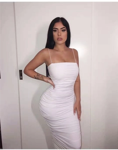 Close-up of ruched white bodycon midi dress with thin straps and elastic fabric