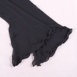 Detail of black sheer mesh sleeve with delicate ruffled lettuce edges and wavy hem finish