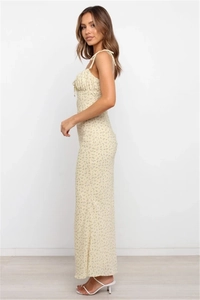 Detailed side view of floral print backless maxi dress with delicate ruching accents