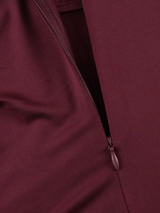 Close-up of seamless invisible zipper detail on premium burgundy fishbone evening dress