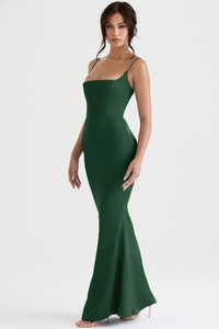 Detail of dark green corset gown with thin straps and elegant satin fishtail hem
