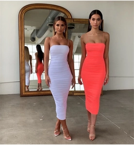 Detail of ruched midi dresses in white and neon orange with slim spaghetti straps