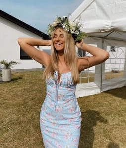 Close-up of floral ruffles and tie-up detail on light blue summer sundress