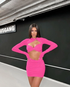 Detail of hot pink cutout long sleeve top and ruched mini skirt set on fashion model