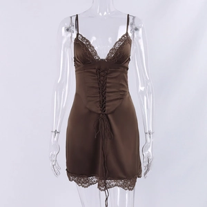 Detailed view of brown satin mini dress with delicate lace trim and waist tie detail
