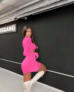 Rear view of neon pink hollow-out crop top and pleated mini skirt set on model