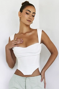 Detail of white corset top featuring heart-shaped neckline and ruched front design