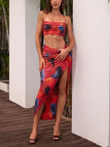 Detail of high-slit long skirt and cropped camisole in vibrant abstract ink print