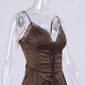 Detailed close-up of brown satin top featuring lace trim and corset-style front lacing
