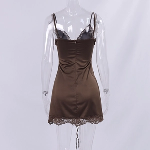 Detail view of the back of a brown satin dress featuring delicate lace trim and hidden zipper