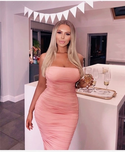 Detail view of pink bodycon dress featuring elegant ruched texture and strapless design