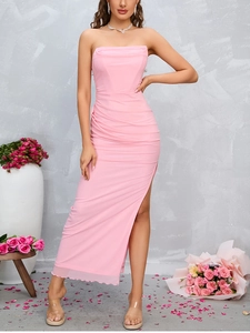 Detail of light pink ruched off-shoulder dress featuring a high side slit and mesh fabric