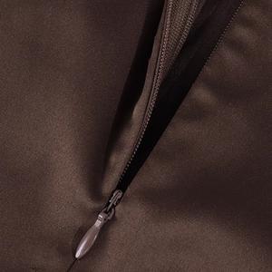 Detailed close-up of a concealed zipper on a brown satin dress with smooth texture