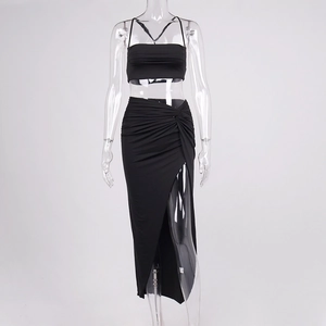Detail of high waist wrap maxi skirt with a deep side slit and gathered knot detail