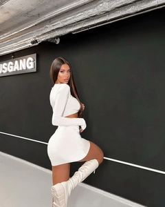 Detail shot of white cutout long sleeve crop top and ruched bodycon skirt set