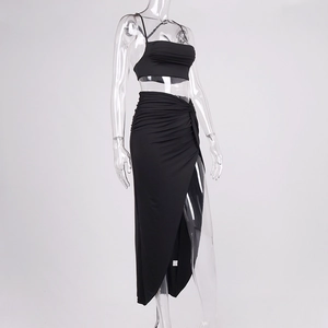 Detail of black two-piece set featuring a cropped cami top and ruched high slit maxi skirt