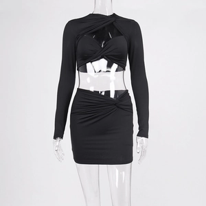 Detail of hollow-out long sleeve top and ruched mini skirt set in black knit fabric