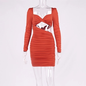 Détail de robe moulante orange à manches longues avec décolleté en cœur et découpe