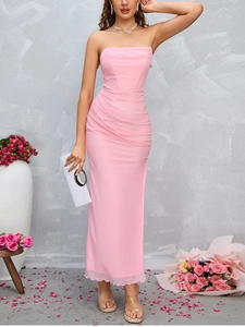 Detail of elegant pink ruched mesh dress featuring a strapless neckline and sleek silhouette