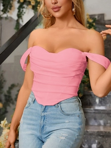 Detail of pink corset top featuring pleated texture and off-shoulder sleeve design