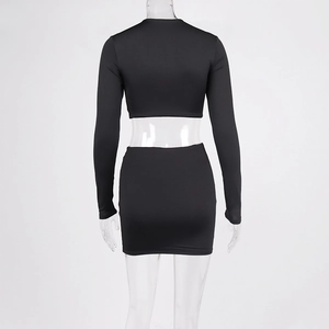 Detail view of the back of black long sleeve crop top and bodycon skirt set
