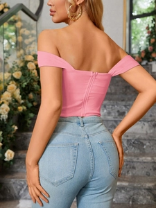 Detail view of the back showing invisible zipper and slim fit on pink crop top