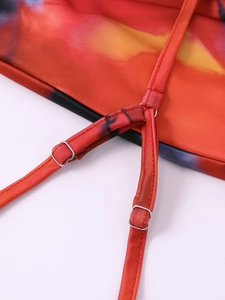 Detail of adjustable thin strap with metal buckle on gradient tie-dye summer dress