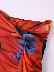 Close-up of vibrant tie-dye fabric with twisted knot detail and elastic pleated edges