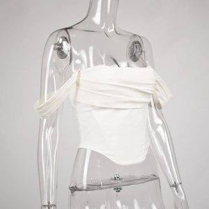 Detail of white corset top featuring pleated square neckline and off-shoulder straps