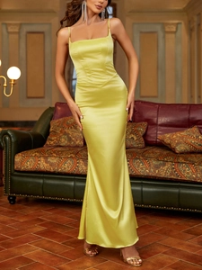 Detail view of lime yellow satin evening dress featuring structured corset waist and fine straps