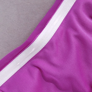 Detailed macro shot of purple honeycomb mesh fabric with non-slip silicone strip on white trim