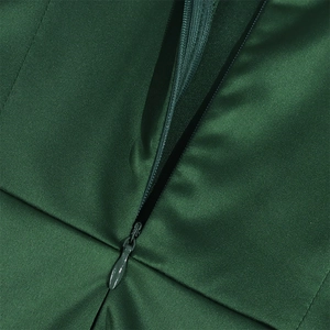 Detailed close-up of high-quality invisible zipper on dark green satin evening dress