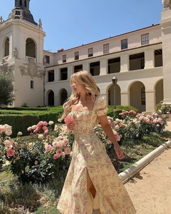 Detail of square neckline and puff sleeves on a floral French split midi dress