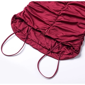 Close-up of wine red summer dress with elegant pleated texture and invisible zipper detail