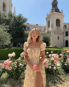 Detail showing the French style floral dress with puff sleeves and elegant high side slit