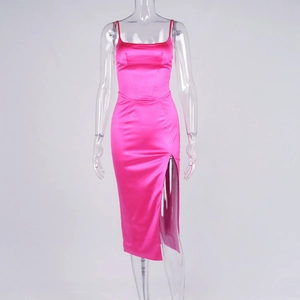 Detail view of pink satin dress with thin straps, side slit and corset-style stitching