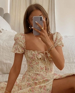 Detailed view of the square milkmaid neckline and tie-up design on floral print dress