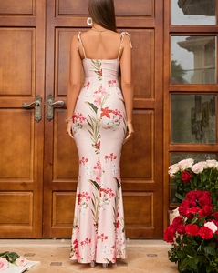 Detail of floral backless mermaid dress with vibrant tropical flower prints and tie-up design