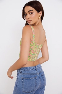 Detailed back view of floral corset top featuring a hidden zipper and slim fit design