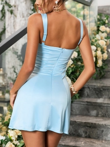 Detail of light blue satin mini dress showing adjustable straps and back invisible zipper