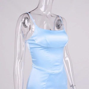 Detail of light blue satin dress featuring corset-style stitching and sleek spaghetti straps