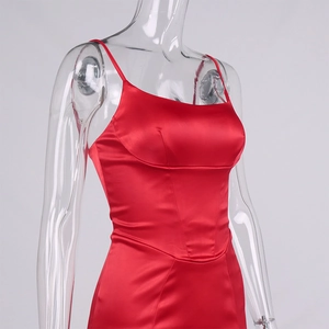 Detail view of red satin slip dress featuring a square neckline and thin straps
