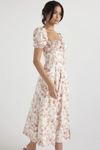 Close-up of floral print dress featuring square neckline, puff sleeves and side slit detail