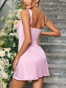 Detail of adjustable straps and satin fabric texture on a pink lace mini dress