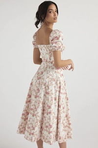 Detail of square neckline and pink floral pattern on a vintage French midi dress