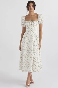 Detail of floral puff sleeve dress featuring square neckline and side slit design