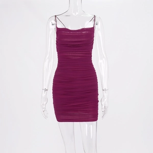 Detailed close-up of dark purple ruched mesh fabric on a sexy bodycon mini dress